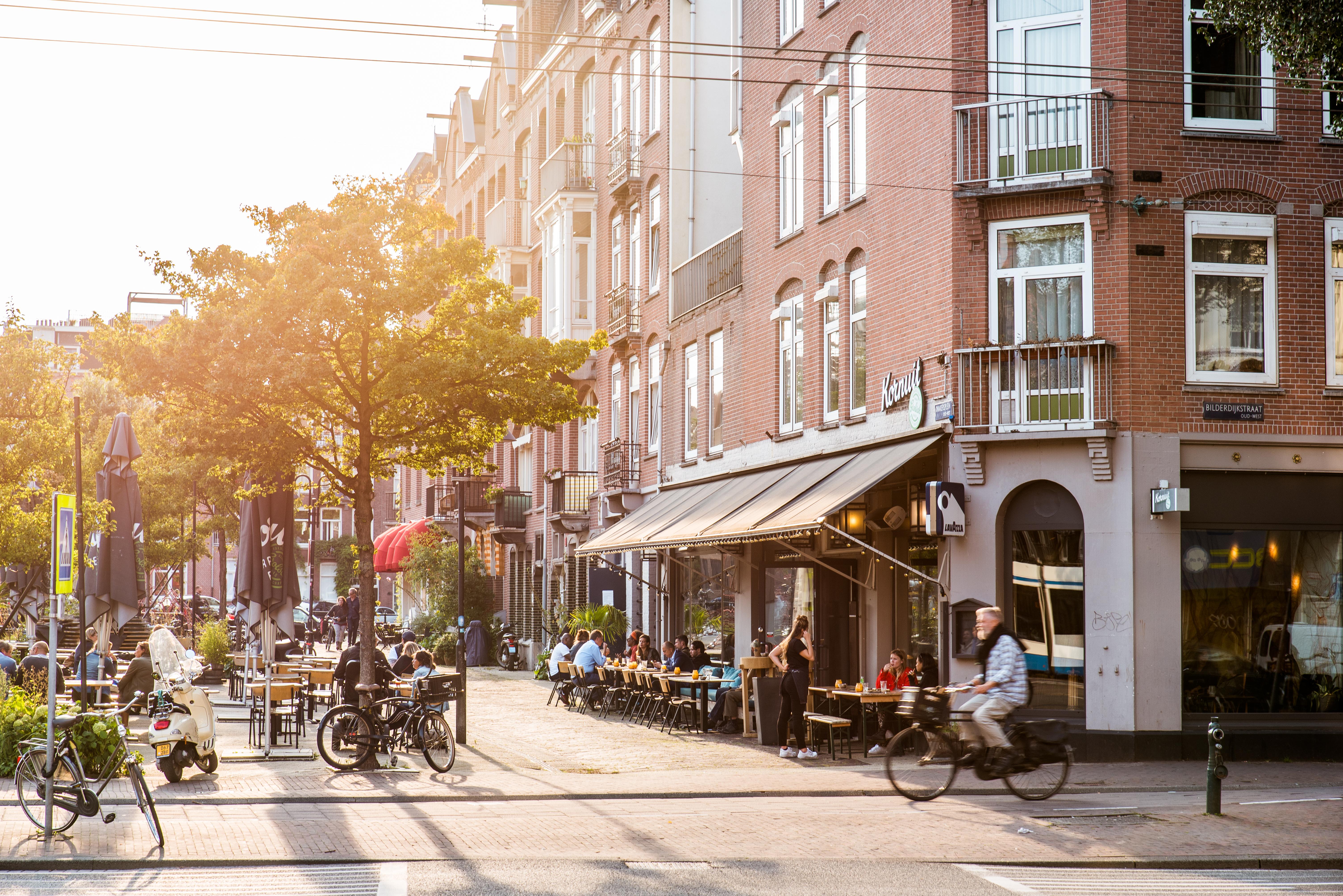 Amsterdam street with bikes, buildings and sunshine.